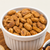 Habanero & Lime Redneck Nutz spicy peanuts in a white bowl on a wooden board. 