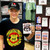 Smiling young man wearing a Uranus Missouri t-shirt and hat while holding a Route 66 souvenir sticker in a gift shop Uranus Fudge Factory.