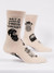 Beige crew socks featuring bearded men illustrations and a funny slogan on a plain white background.