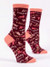 A pair of dark burgundy crew socks displayed against a plain white background. The socks feature peach-colored accents on the toe, heel, and top cuff. They are covered in a chaotic, all-over pattern of stylized pink and peach cat silhouettes in various poses, mixed with the words "CATS!!!" and "CAAATS!!!" repeated wildly with multiple exclamation points.