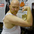 Strong man flexing his arm next to a Redneck Whup Ass novelty jar.