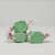 Three pieces of green salt water taffy candies wrapped in wax paper.