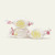 Three pieces of white salt water taffy candies with yellow swirls wrapped in wax paper.
