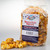 Uranus Style Popcorn package standing beside a loose pile of yellow popcorn snacks by Uranus Fudge Factory.