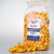 Cheddar popcorn package standing alongside a loose pile of orange popcorn snacks by Uranus Fudge Factory.
