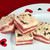 Red velvet fudge squares from Uranus with rich cocoa color and creamy texture on a decorative Valentine's Day plate.
