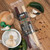 Peppered beef and jalapeño cheese stick twin pack surrounded by fresh jalapeños from Uranus Fudge Factory.