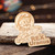 Wooden magnet engraved with Rex Uranus riding a rocket graphic on weathered wood from Uranus Fudge Factory.