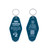 Front and back of a teal Inn Uranus vintage motel keychain on a white background by Uranus Fudge Factory.