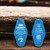 Front and back of a blue Inn Uranus vintage motel keychain displayed on wood from Uranus Fudge Factory.