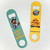 Close up of two novelty metal bottle openers, one teal and one yellow, from Uranus Fudge Factory.