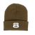A dark olive green knit cuffed beanie hat against a plain white background. The front cuff features a sewn-on white patch shaped like a classic highway shield with an olive green border.