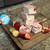 Swirled Strawberry Shortcake fudge squares displayed on a wooden cutting board from Uranus Fudge Factory