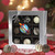 Silver gift box with nine assorted Uranus chocolates displayed on a table with hearts in front of a heart background for Valentine's Day.