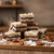Pyramid stack of German chocolate cake fudge squares with coconut and pecans highlighting layered chocolate fudge and coconut-pecan filling on a rustic wooden surface.