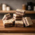 Stacked squares of German chocolate cake fudge with layered chocolate and coconut-pecan filling displayed on a wooden board.