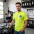 Lifestyle shot of a person wearing the Safety Yellow Uranus Tire & Wheel t-shirt featuring the small left-chest logo.