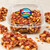 Uranus Fudge Factory peanut brittle in a clear 1 lb. tub with broken pieces of glossy peanut brittle in the foreground