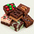 Uranus Holiday Fudge Sampler, six stacked pieces of assorted fudge: M&M's, chocolate walnut, peanut butter chocolate, mint chocolate swirl, dark chocolate sea salt caramel, and white chocolate peppermint cheesecake