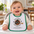 Laughing baby in a high chair wearing the Uranus Cropdusters terry bib with vintage biplane and green trim