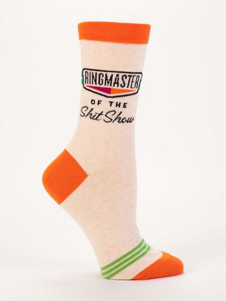 An off-white novelty crew sock featuring orange trim and text that reads "RINGMASTER OF THE Shit Show."
