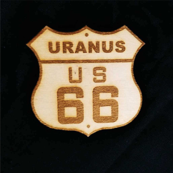Wooden souvenir shield magnet featuring an engraved Uranus US 66 sign from Uranus Fudge Factory.