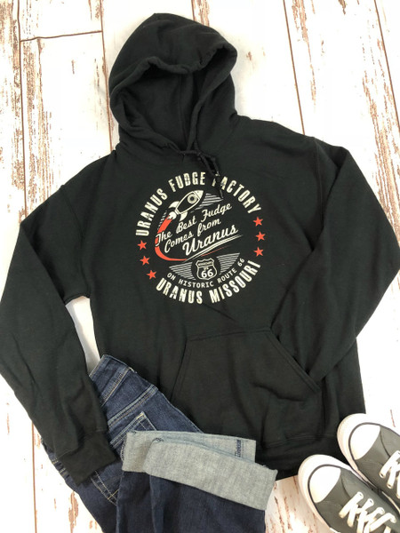 Black Best Fudge novelty hoodie laid flat with jeans and shoes from Uranus Fudge Factory