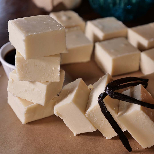Vanilla Fudge from Uranus stacked on a wooden tabletop with some vanilla beans.