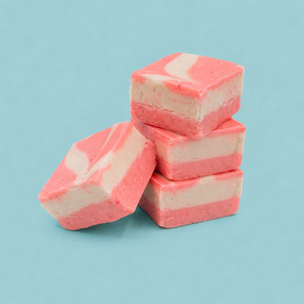 3 piece stack of Uranus Raspberry Vanilla Fudge against a turquoise background. 