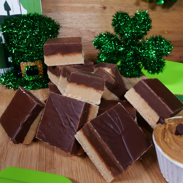 Peanut Butter Choclate Fudge from Uranus on a cutting board with ST. Patrick's Day decor.