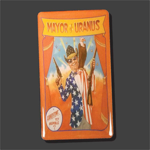 Rectangular novelty magnet featuring a cartoon illustration of the Mayor of Uranus holding weapons from Uranus Fudge Factory.