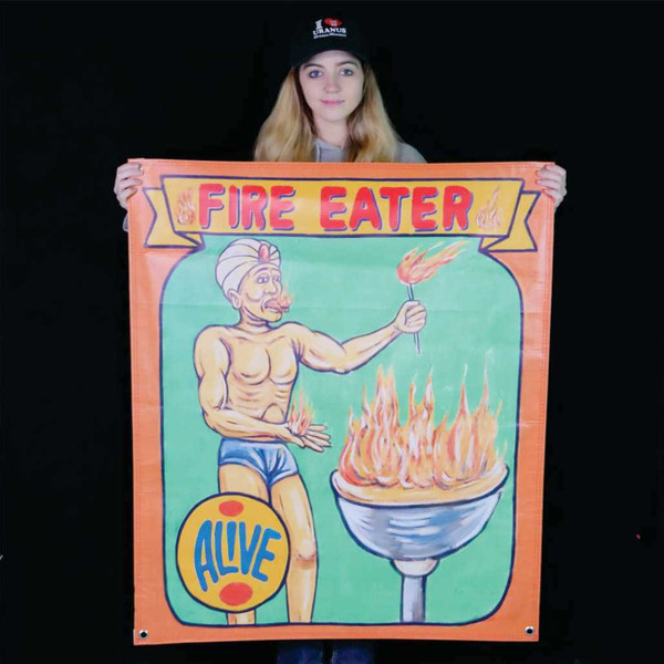 Fire Eater sideshow banner featuring a fire breather, displayed for scale at the Uranus Sideshow Museum