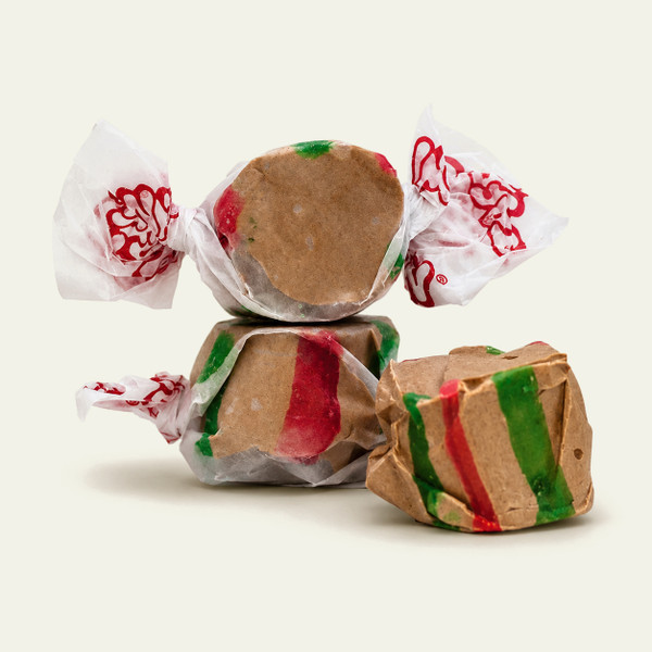 Three wrapped Hot Chocolate saltwater taffy candies stacked together on a plain white background by Uranus Fudge Factory.