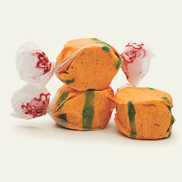 Three colorful wrapped saltwater Chili Mango taffy candies stacked together on a plain white background by Uranus Fudge Factory.