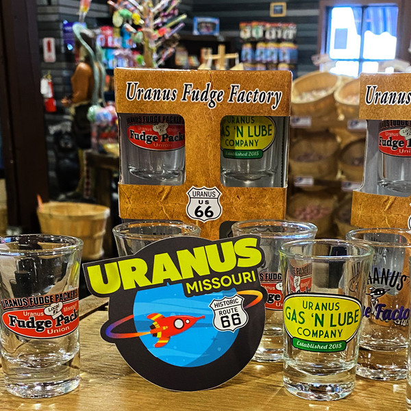 Uranus Missouri planet space logo sticker displayed with glass shot cups from Uranus Fudge Factory