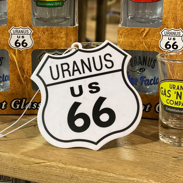Front of Uranus 66 shield shaped new car scented hanging air freshener from Uranus Fudge Factory