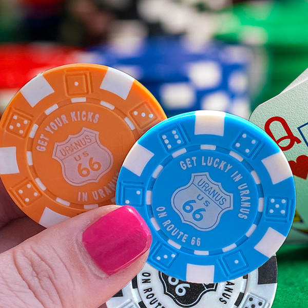 Assorted colorful collectible souvenir poker chips display from Uranus Fudge Factory