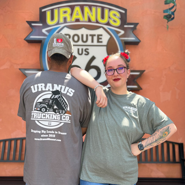 Lifestyle shot of two people modeling the Uranus Trucking Company tees from the Uranus Fudge Factory.