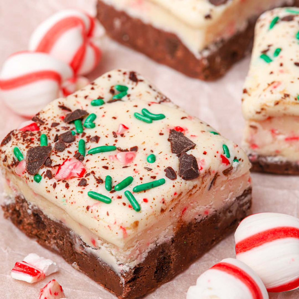 Close-up of creamy white chocolate peppermint cheesecake fudge showing texture, white chocolate chips, and peppermint bits.