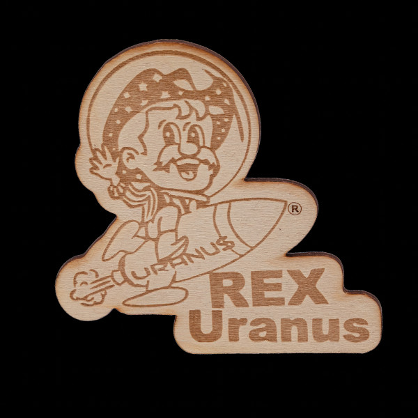 Cutout wooden magnet engraved with Rex Uranus riding a rocket graphic on black from Uranus Fudge Factory.