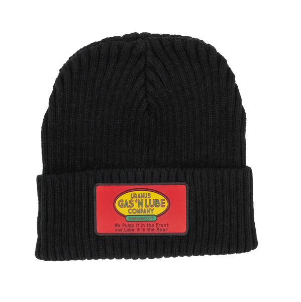 A black ribbed knit beanie hat against a white background. The folded cuff features a rectangular red patch. In the center of the patch is a yellow oval logo reading "URANUS GAS 'N LUBE COMPANY".
