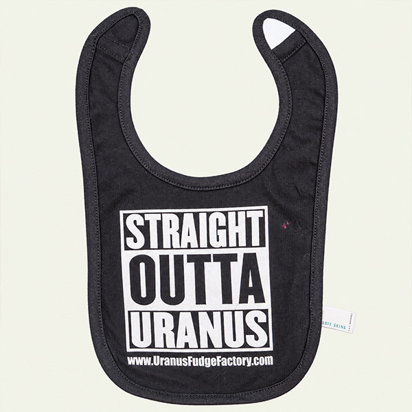 Smiling baby in a high chair wearing the black Straight Outta Uranus bib with white block lettering