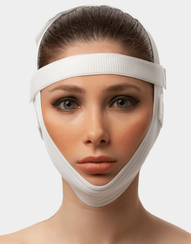Adjustable chin strap facial garment designed to support recovery after facelift, neck lift, and chin liposuction.