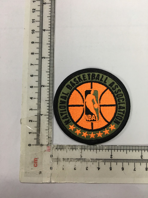Jerry West / NBA Logoman; 65mm Round; 100% Embroidery; Overlock Border; Standard Plastic Backing