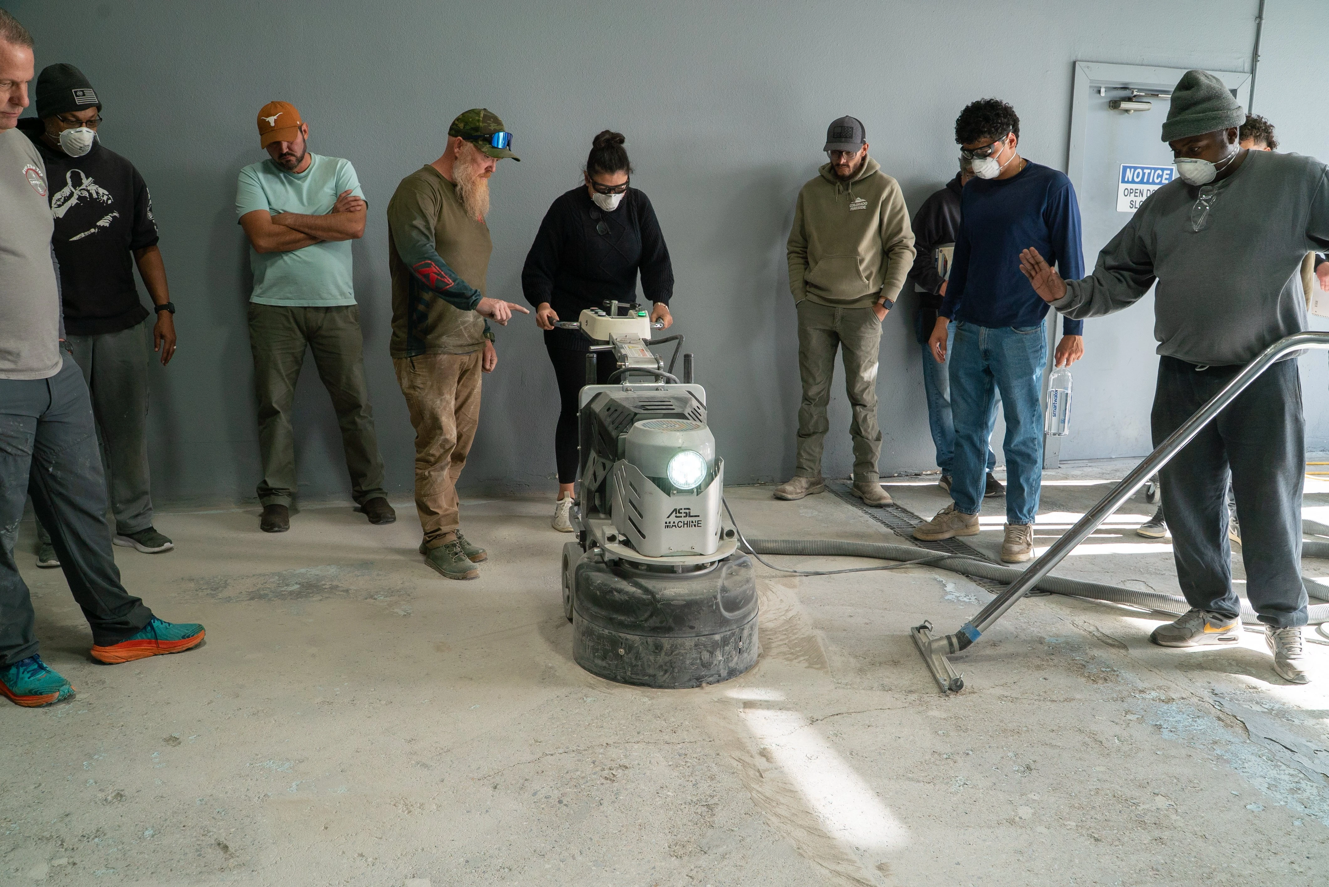 Students watching a live grinder demonstration during a Countertop Epoxy masterclass in Grand Junction, Colorado