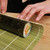 A woven bamboo mat to make sushi rolls