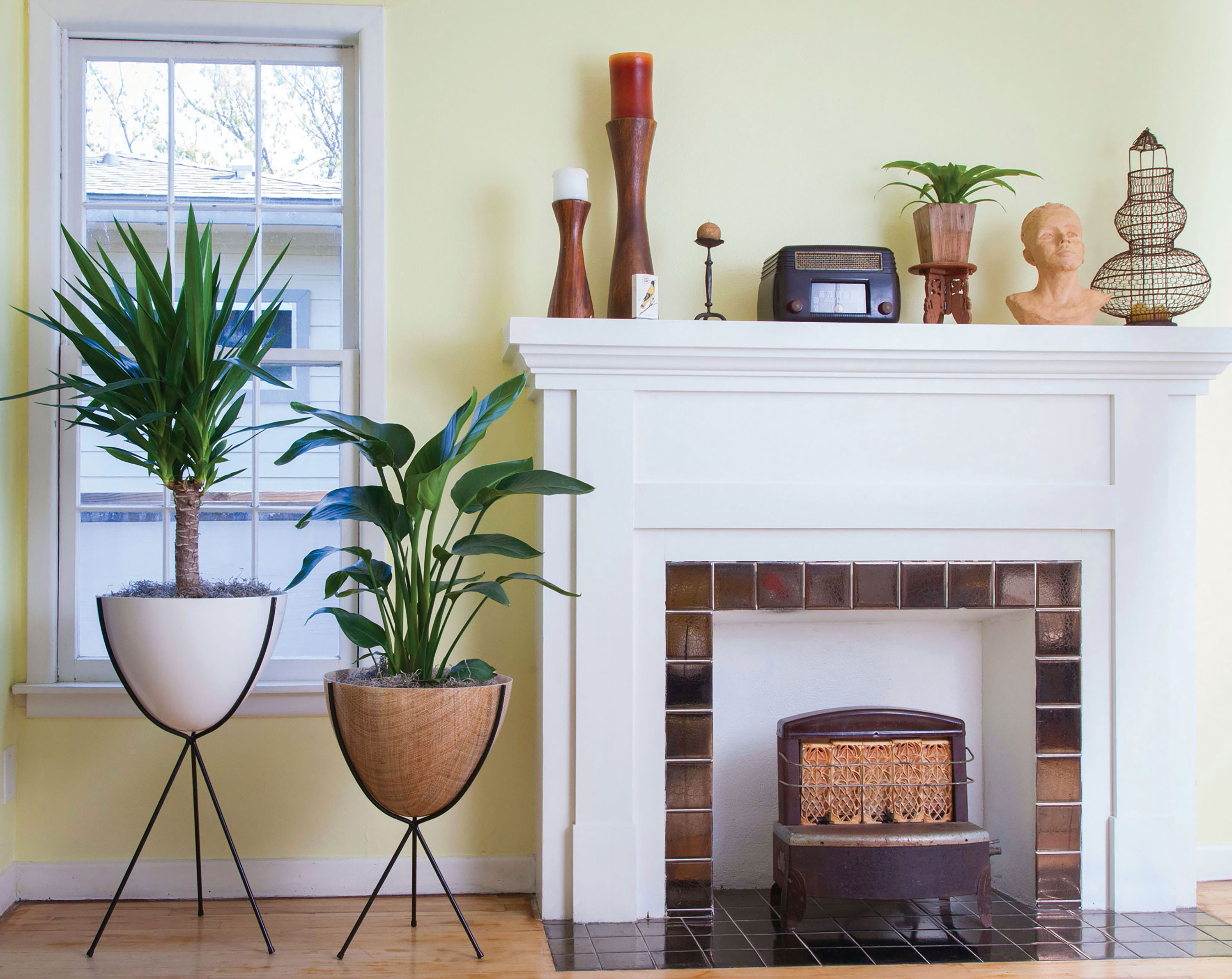 	Two neutral retro bullet planters by a vintage style fireplace


