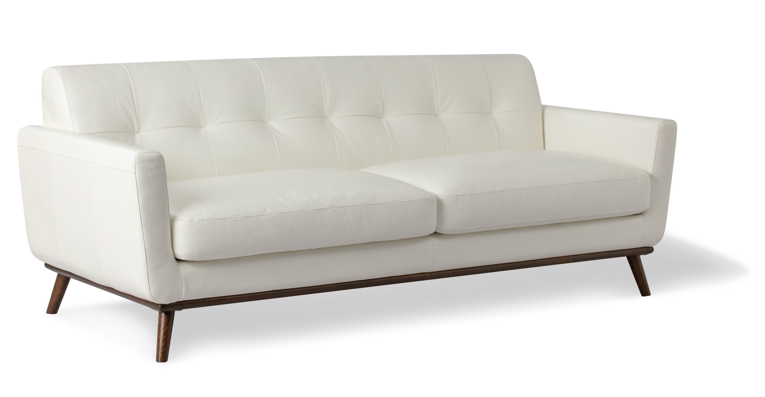 Jackie sofa has a mid century feel. The frame is exposed walnut with slanted walnut legs. The back is affixed and horizontally tufted. The arms are angled out slightly and equal in size to the sofa base. There are two seat cushions which are removable. 