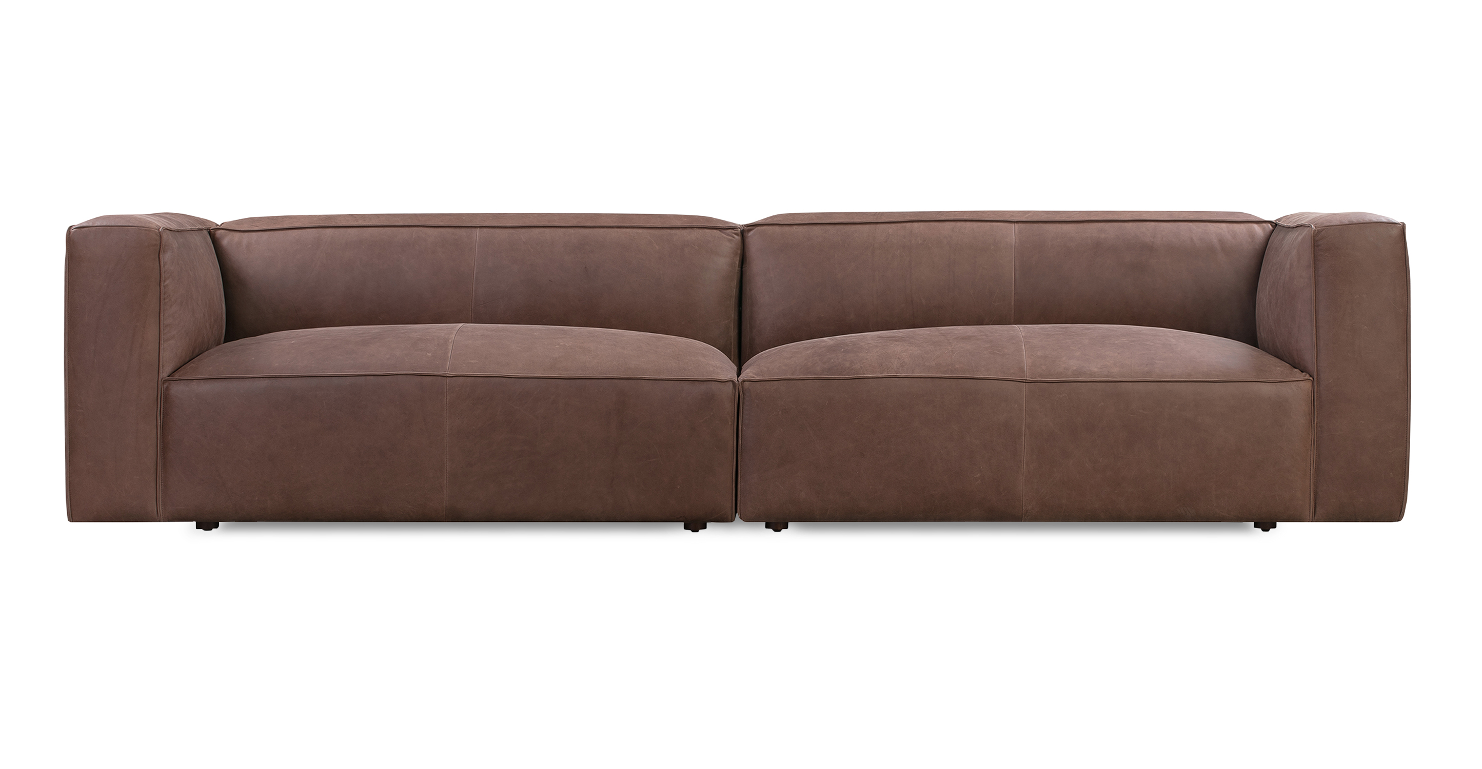 Soho Mocha 110 sofa has a modern and sleek low profile. The sofa part of a modular set, two separate single arm sofas are used to create one large open sofa. This series is supported by small black legs that allow the sofa to be close to the floor without touching. The sofa seat cushion is one thick solid piece, the arms and back are rectangle in shape. All the cushion edges are finished in piping and have interest seams to visually divide up the one seat cushion. 