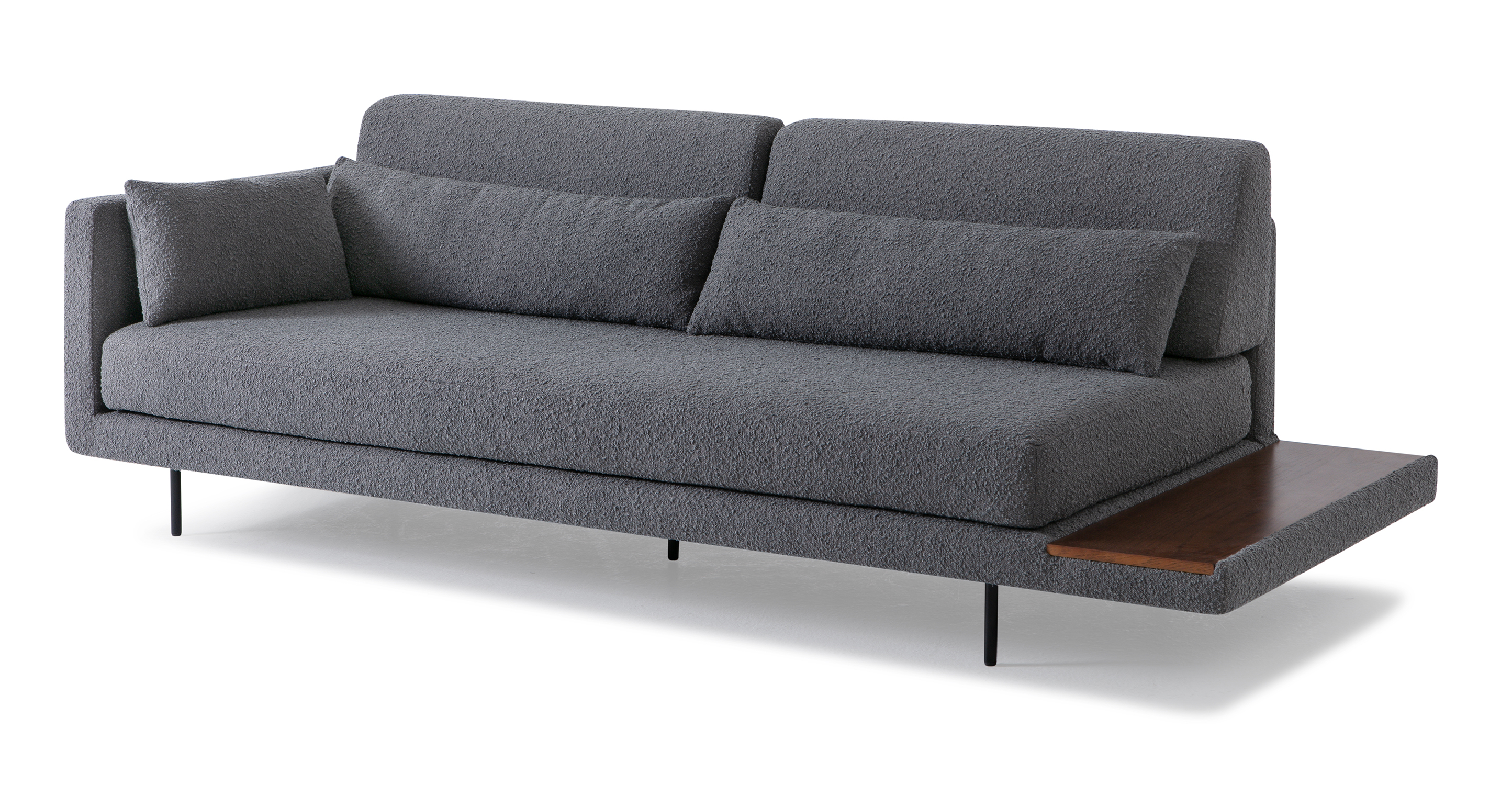 Davenport Gris Boucle fabric daybed sofa is a sleek modern sofa with 5 narrow black metal lets. When facing the sofa, the left portion has an upholstered arm and the right of the sofa is open and have a built-in end table with wooden top. The seat cushion of the sofa is a once piece cushion and one arm pillow. The back has two cushions and two bolsters. To enlarge the sleeping area, remove the back cushions and bolsters. This vibe of this item is minimalist and balances a smooth, modern and comfortable style.